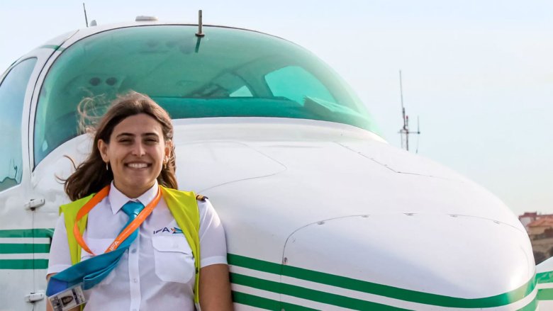 women pilot student near aircraft